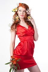 Image showing Portrait of woman in red dress with spring flowers on white