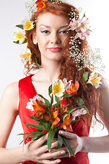 Image showing Portrait of beautiful woman with spring flowers