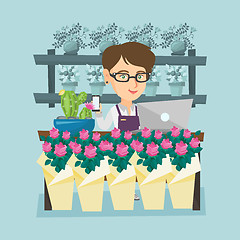 Image showing Florist standing behind the counter at flower shop