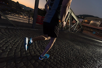 Image showing man jogging across the bridge in the city