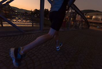 Image showing man jogging across the bridge in the city