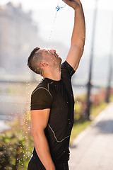 Image showing man pouring water from bottle on his head