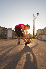 Image showing athlete woman warming up and stretching