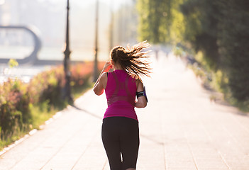 Image showing woman jogging at sunny morning