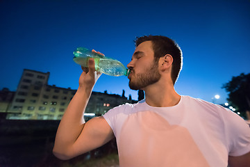 Image showing man drinking water after running session