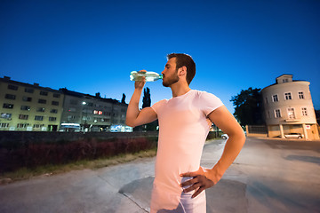 Image showing man drinking water after running session