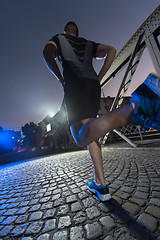 Image showing man jogging across the bridge in the city