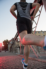 Image showing man jogging across the bridge at sunny morning