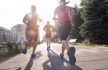 Image showing group of young people jogging in the city