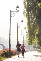 Image showing young couple jogging  in the city