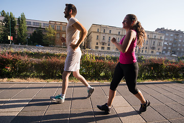 Image showing young couple jogging  in the city