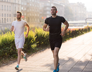 Image showing group of young people jogging in the city