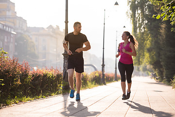 Image showing young couple jogging  in the city