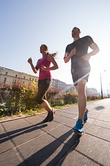 Image showing young couple jogging  in the city