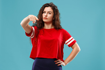 Image showing The overbearing business woman point you and want you, half length closeup portrait on blue background.