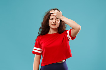 Image showing Beautiful woman in stress isolated on blue