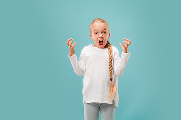 Image showing Portrait of angry teen girl on a blue studio background