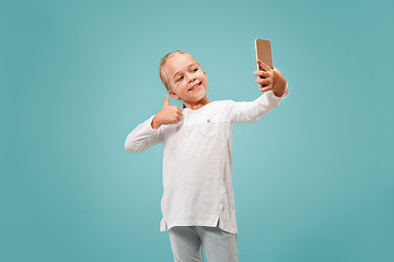 Image showing The happy teen girl making selfie photo by mobile phone