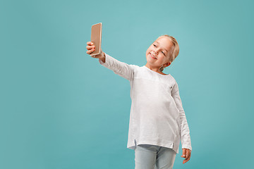 Image showing The happy teen girl making selfie photo by mobile phone