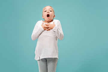 Image showing Beautiful teen girl looking suprised isolated on blue