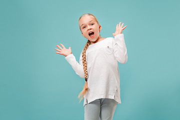 Image showing Beautiful teen girl looking suprised isolated on blue