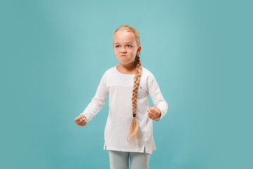 Image showing Portrait of angry teen girl on a blue studio background