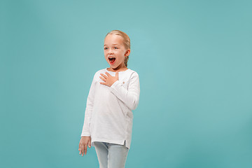 Image showing Happy young beautiful girl singing isolated on blue background