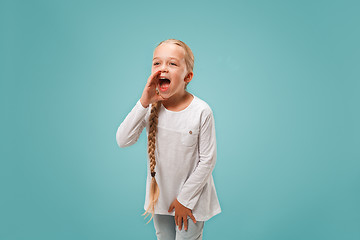 Image showing Isolated on pink young casual teen girl shouting at studio