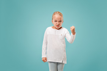 Image showing Portrait of angry teen girl on a blue studio background