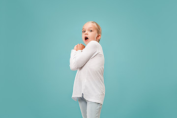 Image showing Portrait of the scared girl on blue