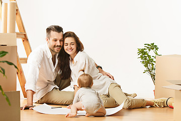 Image showing Couple moving to a new home - Happy married people buy a new apartment to start new life together