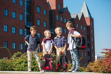 Image showing A group of children of school and preschool age are standing against sity