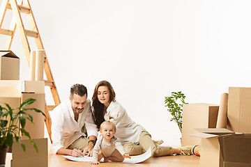 Image showing Couple moving to a new home - Happy married people buy a new apartment to start new life together