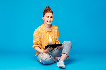 Image showing red haired teenage girl using tablet computer