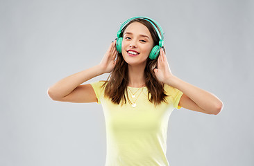 Image showing happy young woman or teenage girl with headphones