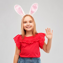 Image showing happy girl wearing easter bunny ears waving hand