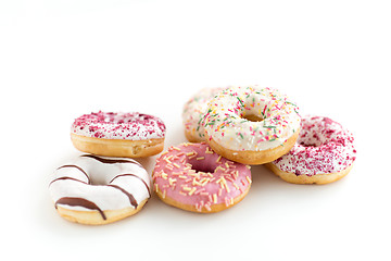 Image showing close up of glazed donuts on white table