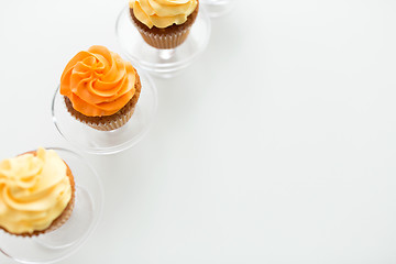 Image showing cupcakes with frosting on confectionery stands