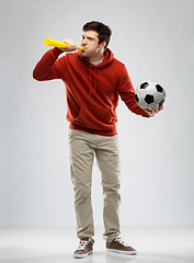 Image showing football fan with soccer ball blowing horn