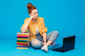 Image showing sad red haired teenage student girl with laptop