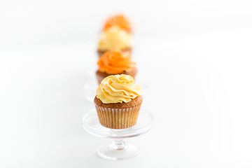 Image showing cupcakes with frosting on confectionery stands