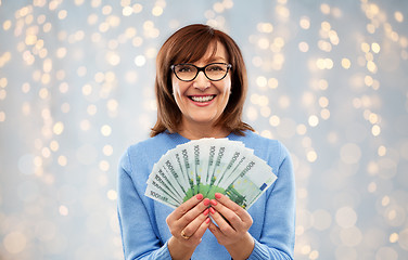 Image showing senior woman with hundreds of euro money banknotes