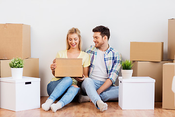 Image showing happy couple with boxes moving to new home