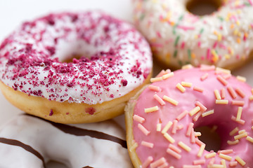 Image showing close up of glazed donuts on white table