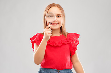 Image showing happy girl looking through magnifying glass