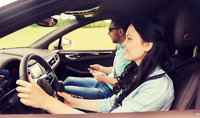 Image showing happy man and woman driving in car