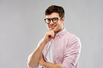 Image showing smiling young man in glasses over grey background