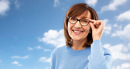 Image showing portrait of senior woman in glasses over grey