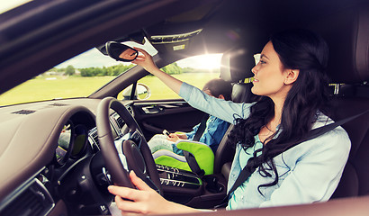 Image showing happy woman with little child driving in car