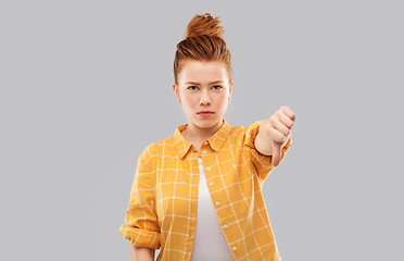 Image showing angry red haired teenage girl showing thumbs down